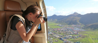 woman taking photos from helicopter