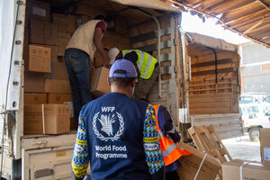 WFP workers unload assistance for the Ebola response in DRC. Photo: WFP/Arete/Seros Muyisa
