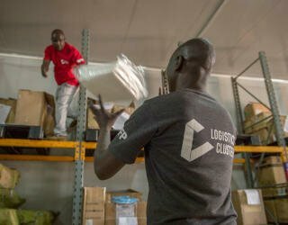 Logistics Officers check personal protective equipment (PPE) being offloaded at the temperature controlled warehouse in Lologo, Juba. Photo: WFP/Giulio d'Adamo